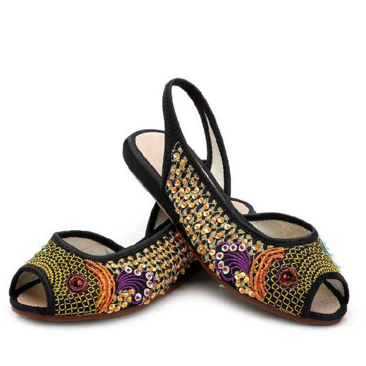 Close-up of embroidery, beads, sequins, and shimmering thread on satin upper